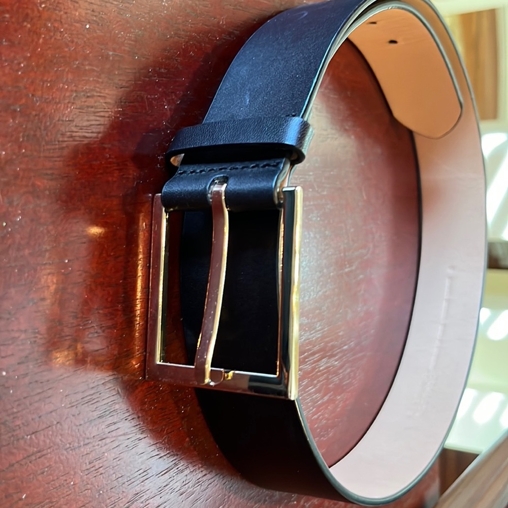Woman’s black belt with large gold buckle